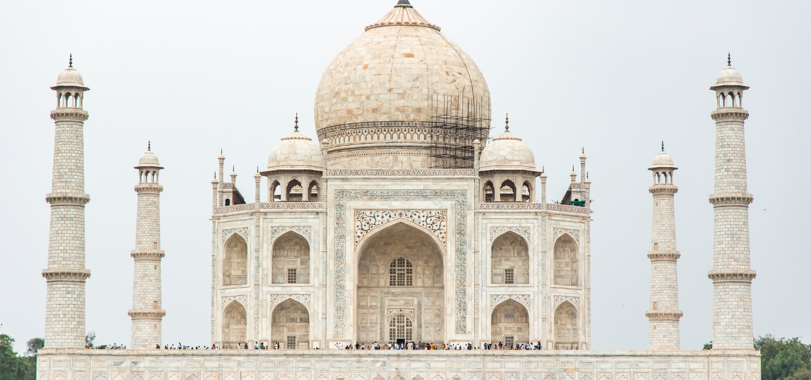 taj mahal standing majestically under cloudy sky